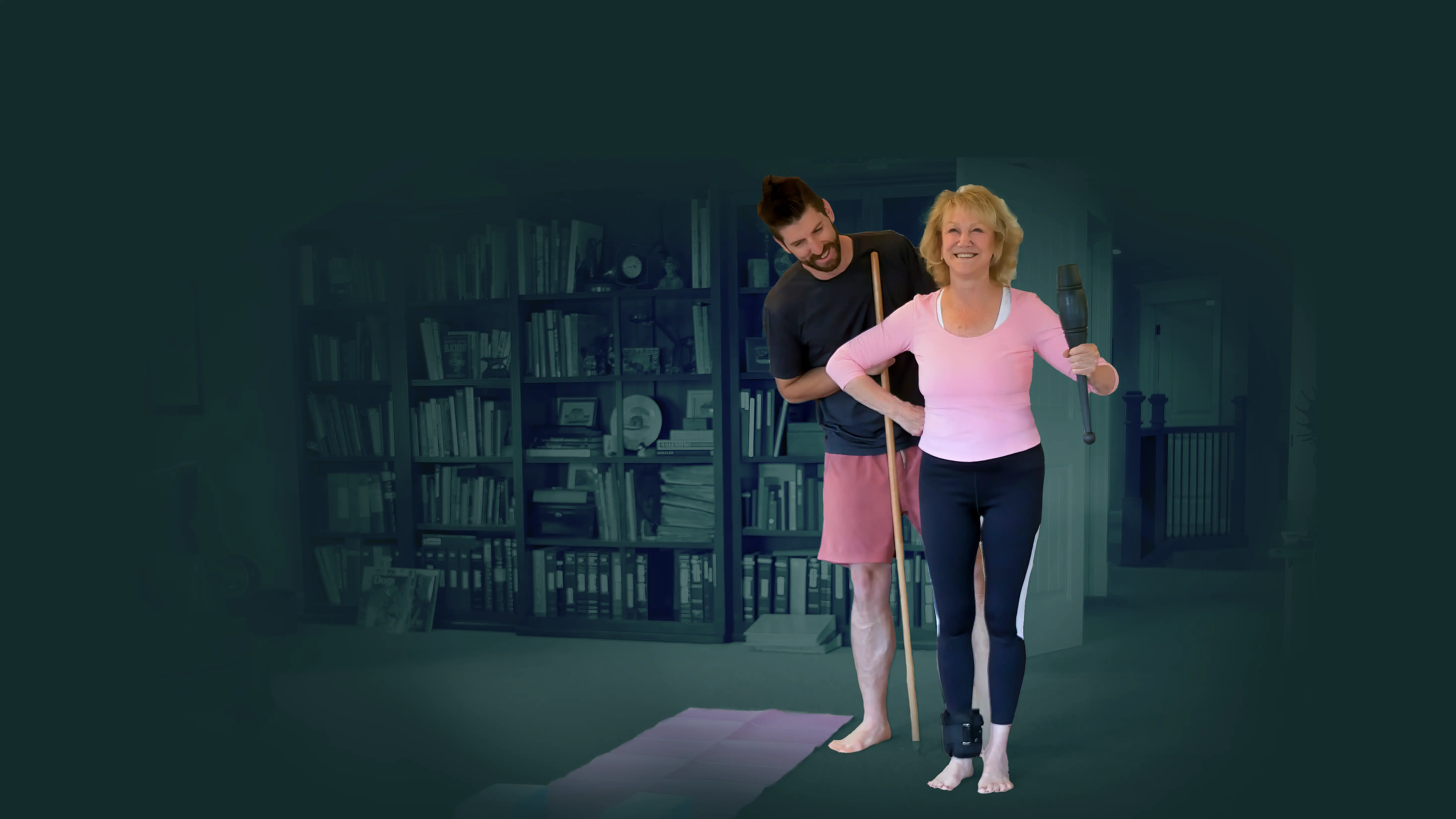 Dixon coaching a client through a standing mobility drill in her home